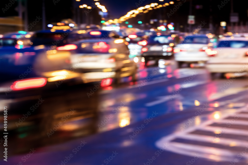 blurred view of cars in motion with bright headlights. city road at night. blurred view of cars in motion with bright headlights. city road at night.