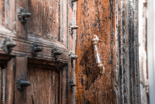 Mezuzah is attached to a wooden antique door. Jewish religious symbols (1291)
