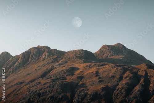 Dramatic mountain landscape view with a moon in Blea Tar, Lake District, United kingdom