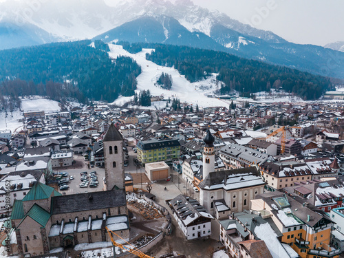 Scenic townscape and snow covered mountain range during winter photo