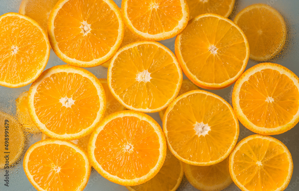 Juicy citrus fruits. Orange slices on a light background. Top view. Healthy natural product. Juicy citrus fruits. Orange slices on a light background. Top view. Healthy natural product.