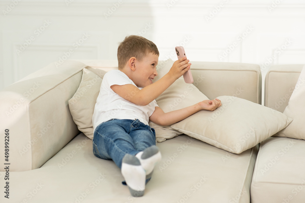 The boy holds the phone and shows his mother something on the phone. The boy holds the phone and shows his mother something on the phone.