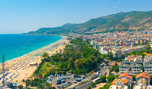 Fototapeta Naklejka Na Ścianę i Meble -  Hot summer day on Kleopatra Beach, cityscape of Alanya. Turkey