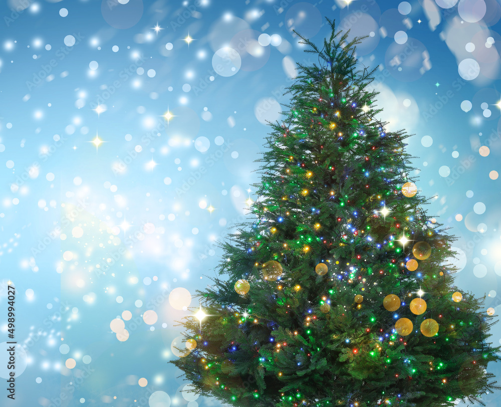 Beautifully decorated Christmas tree on light blue background, space for text. Bokeh effect Beautifully decorated Christmas tree on light blue background, space for text. Bokeh effect