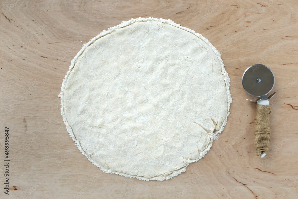 Pizza dough on wooden background, top view Pizza dough on wooden background, top view