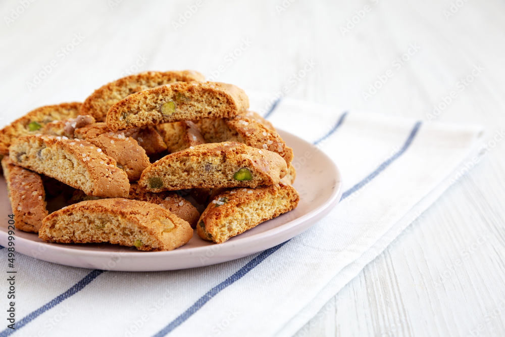 Homemade Italian Cantuccini with Pistachios and Citron on a Plate, side view. Crispy Pistachio and Citron Cookies. Copy space.