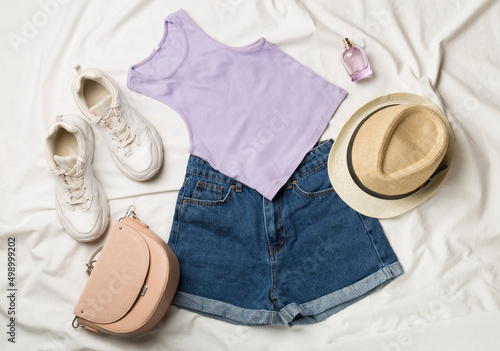 Canvas Print Flat Lay with women casual outfit on white bed sheet, top view