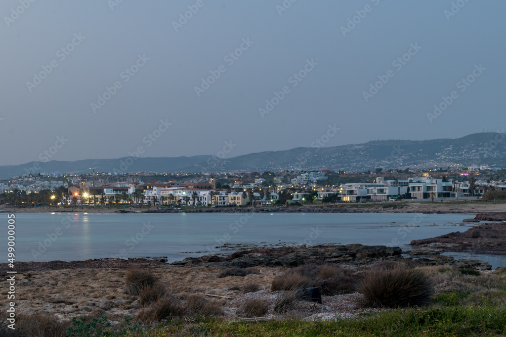 Fototapeta premium Landmark view on Mediterranean seashore with Paphos city in the evening.
