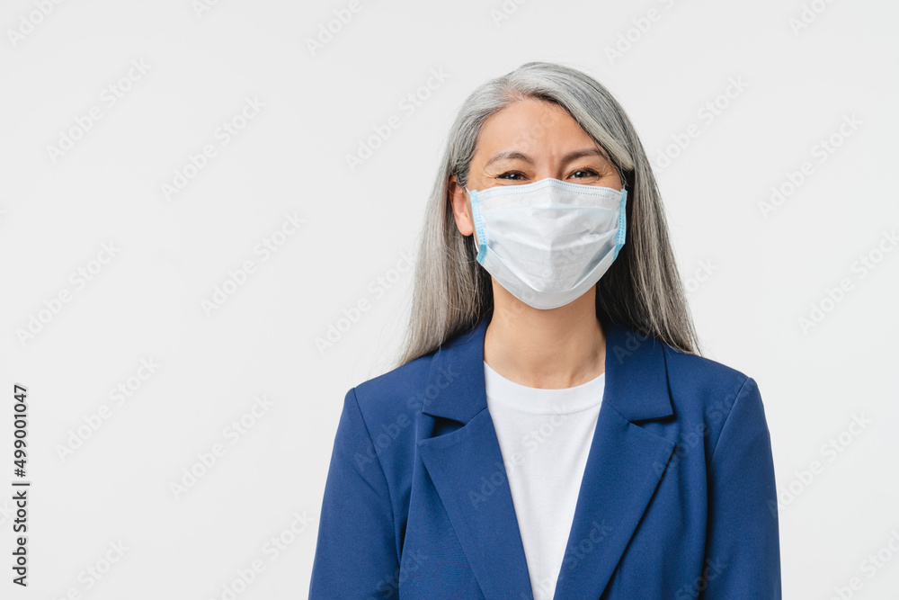 Pandemic, social distance, isolation concept. Caucasian mature middle-aged businesswoman teacher bank manager wearing protective face mask against coronavirus isolated in white background Pandemic, social distance, isolation concept. Caucasian mature middle-aged businesswoman teacher bank manager wearing protective face mask against coronavirus isolated in white background