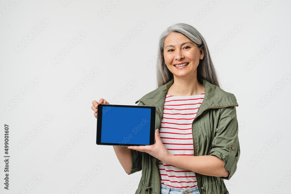 4g 5g. Caucasian mature woman showing digital tablet blue screen with mockup for copy space, mobile application online, e-banking, e-commerce isolated in white background 4g 5g. Caucasian mature woman showing digital tablet blue screen with mockup for copy space, mobile application online, e-banking, e-commerce isolated in white background