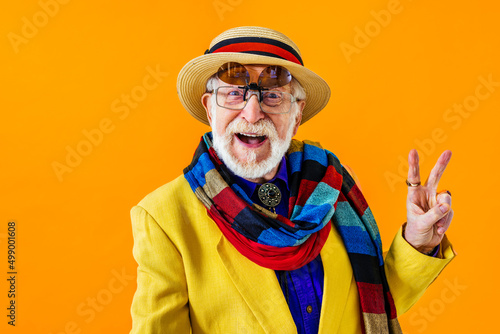 Cool senior man with fashionable outfit portrait - Funny old male person with cool and playful attitude on colorful background