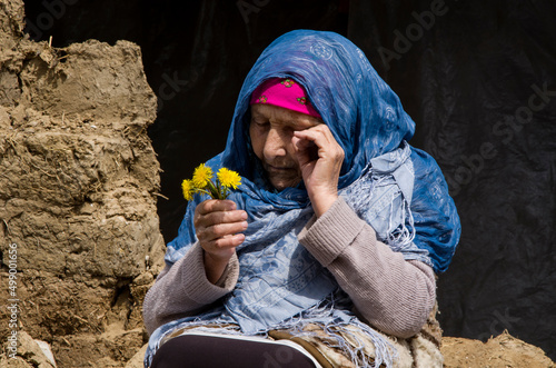 Woman in tears because of the war. Ukrainian woman near a destroyed house during the war. War in Ukraine. Peace concept. Consequences of the war in Ukraine. Ukrainian refugees photo