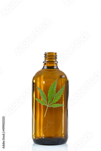 Cannabis leaf in a bottle - Conceptual image on white background.