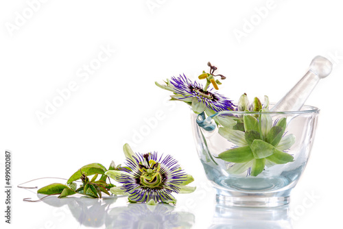 Image of passionflowers in a glass mortar isolated on white background. photo