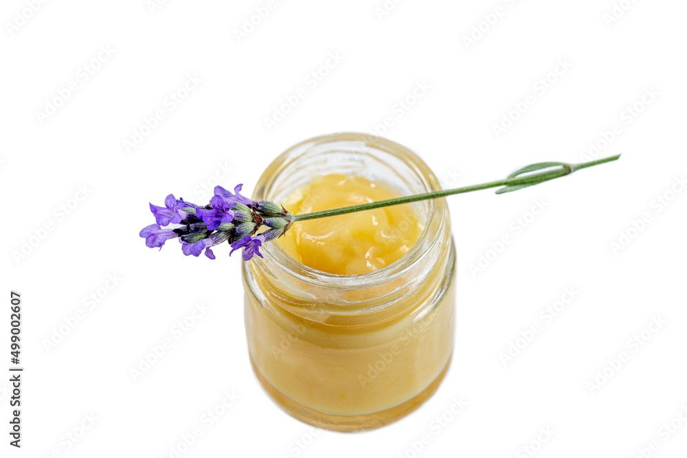 Close up of a jar of royal jelly covered by a sprig of lavender. Close up of a jar of royal jelly covered by a sprig of lavender.