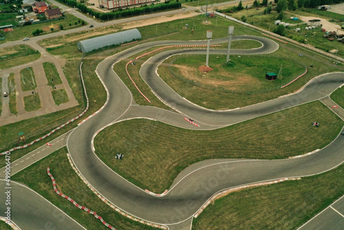 Aerial view of karting track. Go kart racing circuit. Contemporary curving race track for driving, top view from above