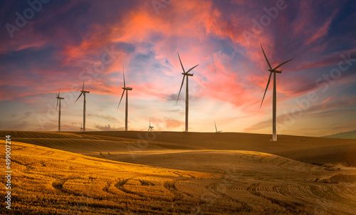 Wind generators in Sherman County Oregon wheat country are shown against a sunrise sky.    Located a few miles south of the Columbia River Gorge.