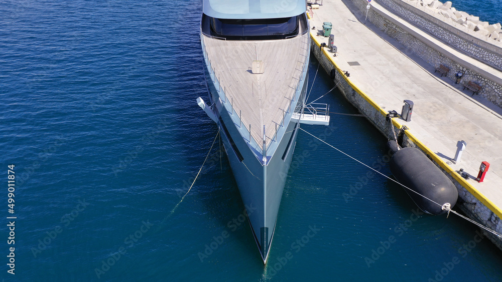 Aerial drone top down photo of luxury yacht anchored in Mediterranean port