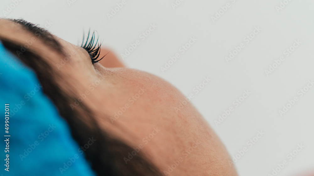 Close-up of a woman's eyelashes on a white background. Close-up of a woman's eyelashes on a white background.