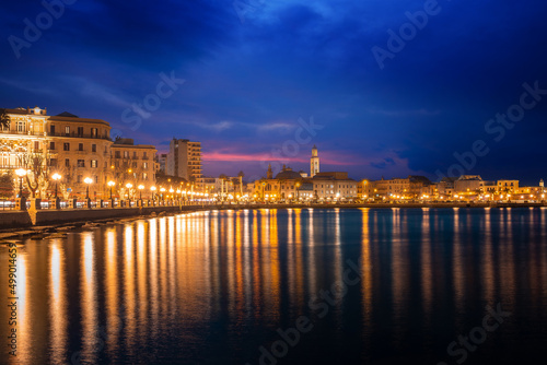 Panoramic view of Bari  Southern Italy  the region of Puglia Apulia  seafront at dusk. Basilica San Nicola in the background. 