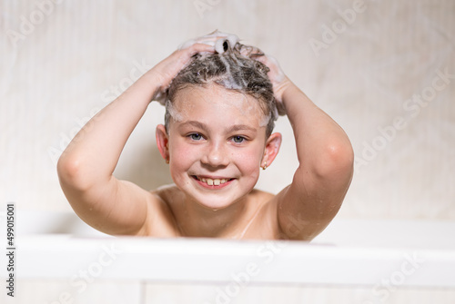 Happy bathing baby with foam on his head