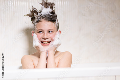 Vászonkép Happy bathing baby with foam on his head