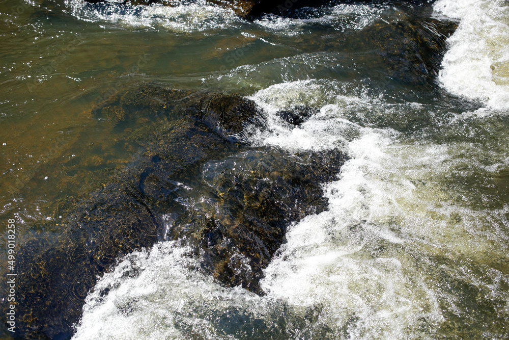 White Water Over Rocks in a Stream Background Texture White Water Over Rocks in a Stream Background Texture