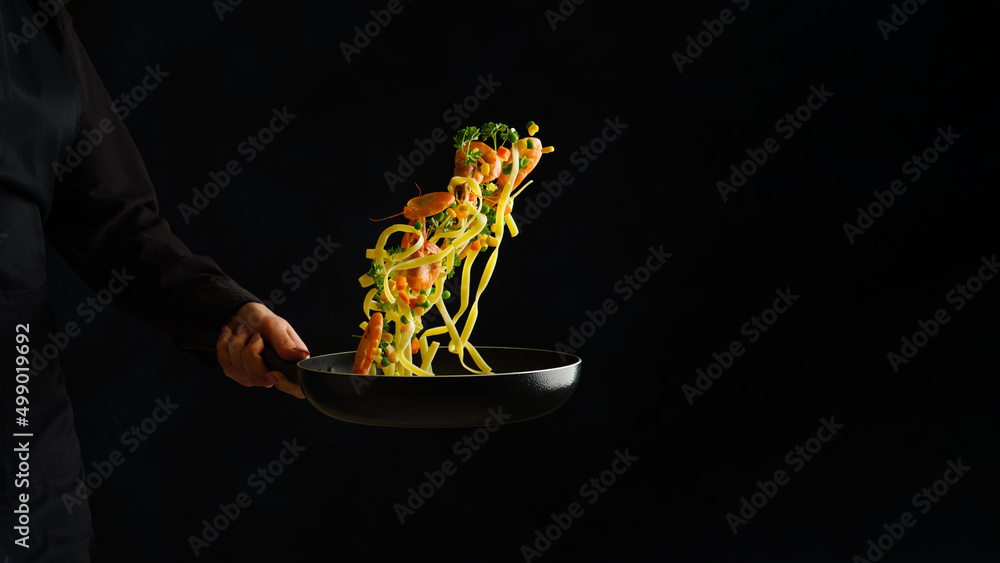 Sea food. Seafood with vegetables and pasta in a pan on a black background.  Italian cuisine, organic food, healthy lifestyle. Restaurant, hotel, menu  design. Advertising, banner. Stock Photo | Adobe Stock