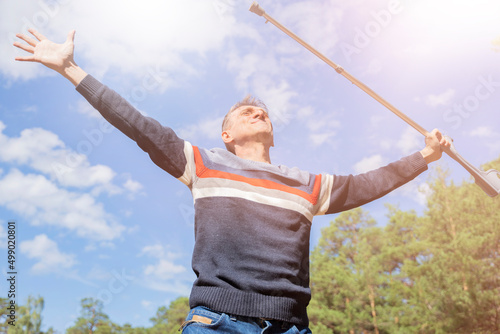 Obraz na plátne a disabled man with a walking stick rejoices in healing recovery