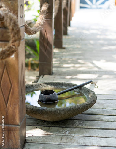 A bowl and ladle for washing feet at the entrance to a spa in the Maldives