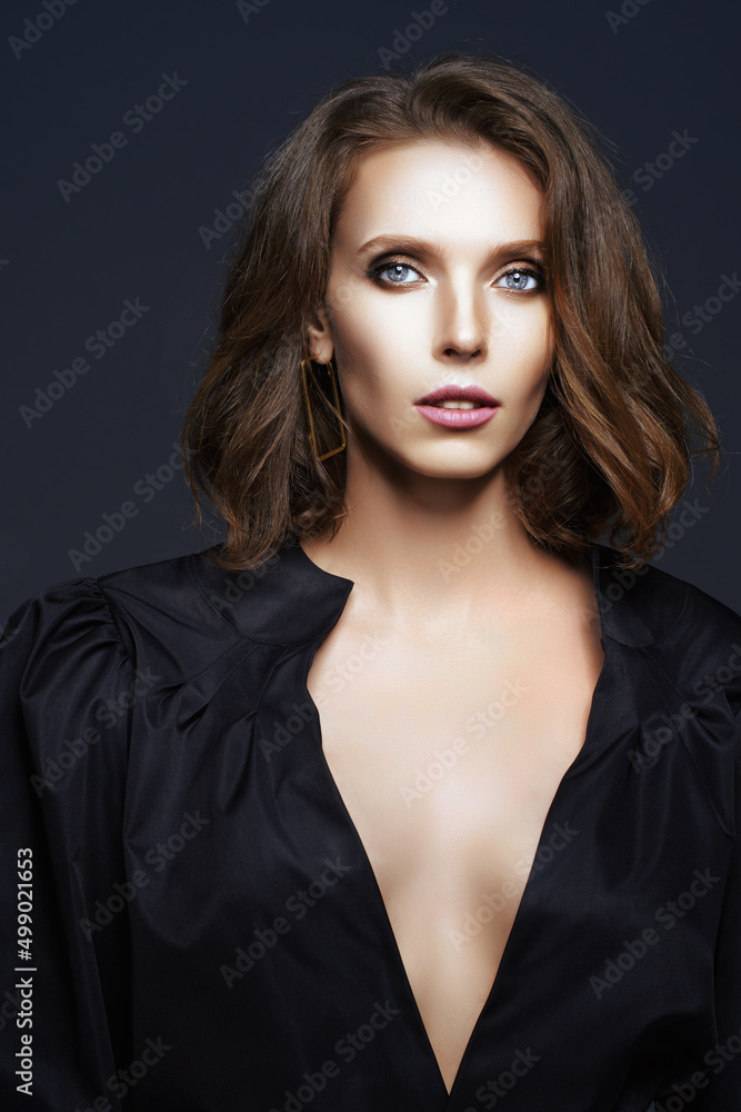 Portrait of beautiful brunette woman in black dress who isolated on dark background. Fashion photo Portrait of beautiful brunette woman in black dress who isolated on dark background. Fashion photo