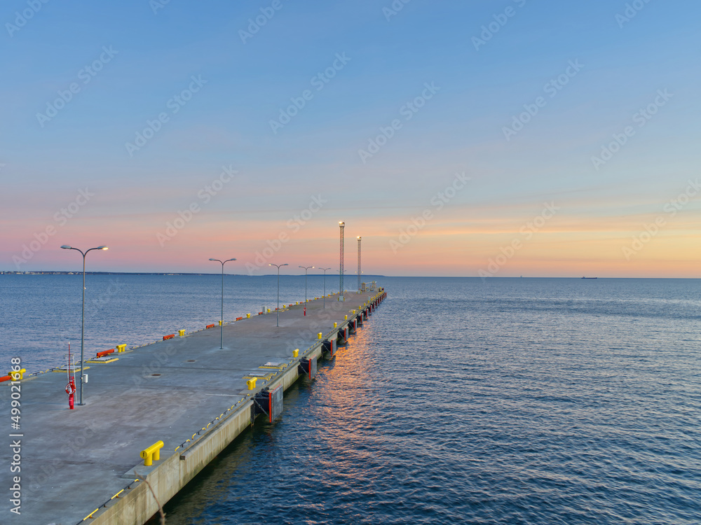 Beautiful view of a pier sunset in Tallinn. Blue sky landscape. Estonia marine at evening. close up Beautiful view of a pier sunset in Tallinn. Blue sky landscape. Estonia marine at evening. close up
