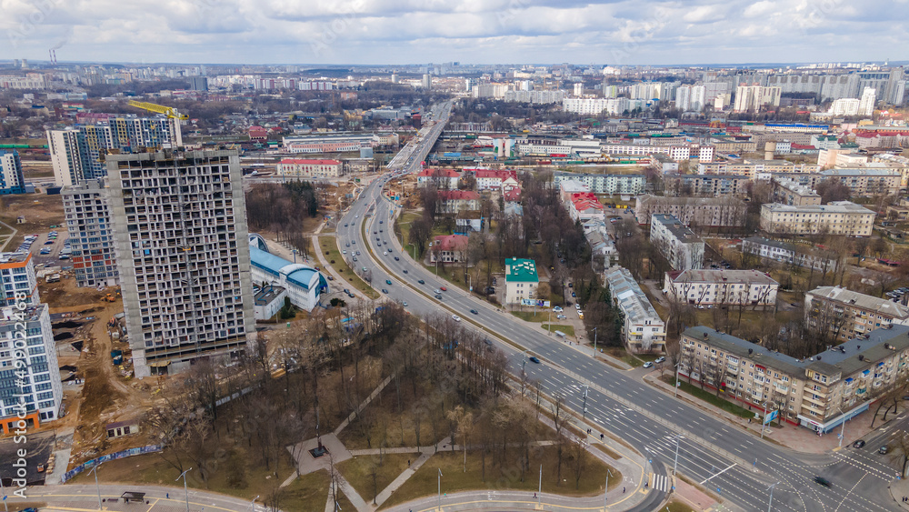 New multi-storey residential building apartment houses aerial view with children playground. City neighbourhood.