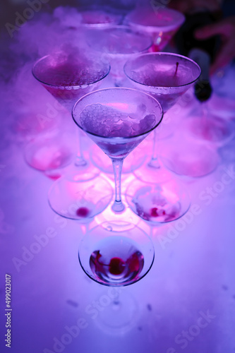 Glasses of champagne with dry ice. Champagne slide. Pyramid or fountain made of champagne glasses