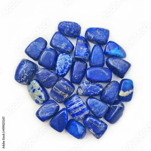 Fotografija Closeup of a pile of Lapis Lazuli gemstones isolated on white background