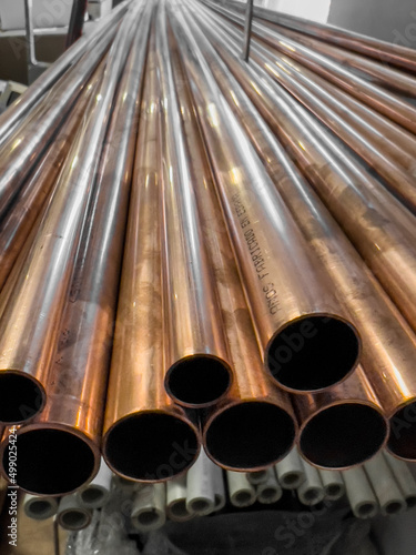 Fotografía copper pipes stacked on a rack in a warehouse