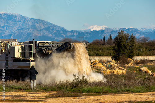 Stone filled rock crusher with stone crusher and bucket photo