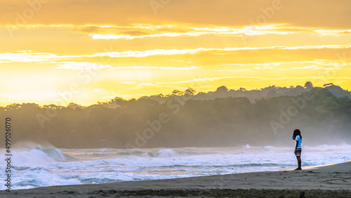 Fototapeta Naklejka Na Ścianę i Meble -  Sunrise at Playa Cocles, beautiful tropical Caribbean beach, Puerto Viejo, Costa Rica east coast, tourists meet the dawn