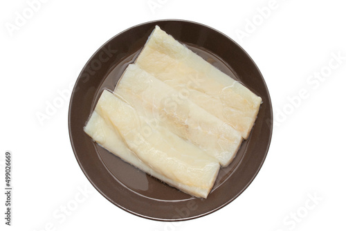 Cod in soak, to desalt. To make a widely consumed meal during Easter, in Spain, chickpeas with cod. Isolated on white background. Spanish traditional foods.