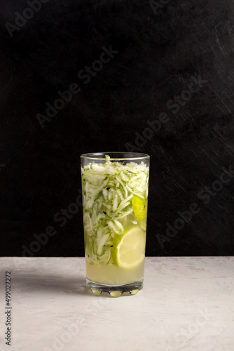 Es Timun Serut or Le Both Timon. Indonesian Refreshment Drink based on cucumber with lime and sweet basil seeds. Popular during ramadan. Dark background, copy space