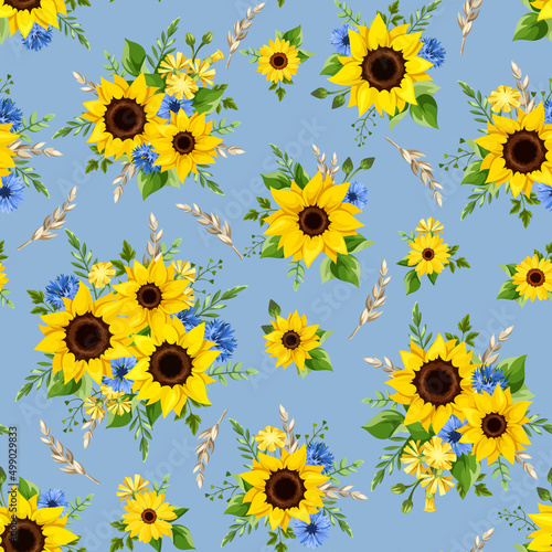 Vector seamless pattern with yellow sunflowers, blue cornflowers, and wheat ears on a blue background