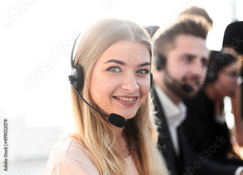 young call center operators on the background of her colleagues