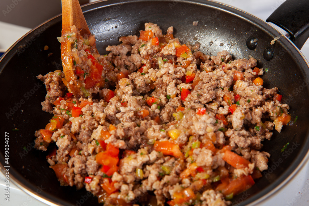 Preparation of ground beef with the traditional Colombian hogao or criollo sauce (salsa criolla) made of onion, tomato, peppers and cilantro Preparation of ground beef with the traditional Colombian hogao or criollo sauce (salsa criolla) made of onion, tomato, peppers and cilantro