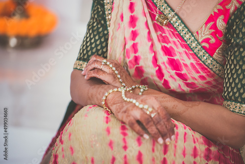 Indian bride's hands, gloves, rings, mehendi and jewellery close up