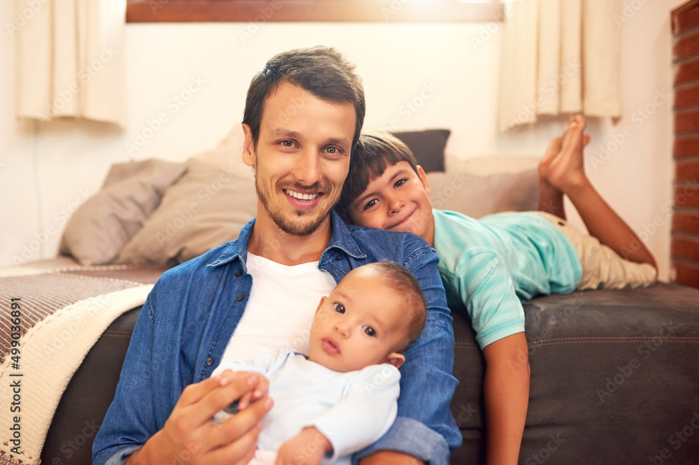 Its just me and my boys today. Cropped portrait of a handsome young dad and his two sons spending quality time together at home. Its just me and my boys today. Cropped portrait of a handsome young dad and his two sons spending quality time together at home.