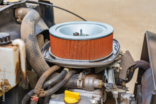 Air filter on lawn mower tractor. Small engine repair, maintenance and tune up concept