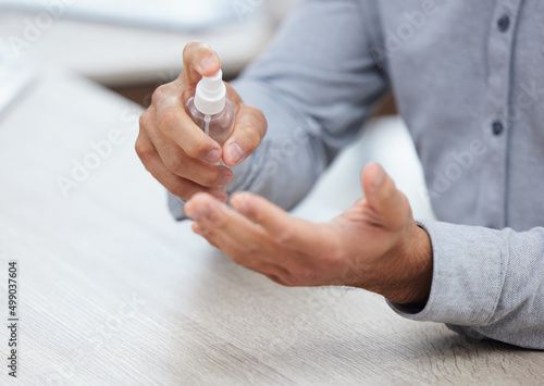 My hands have never been cleaner. Shot of a businessman sanitising his hands.