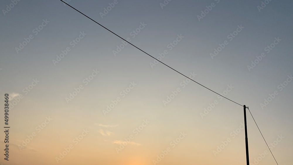 Electric power pole on morning sky background