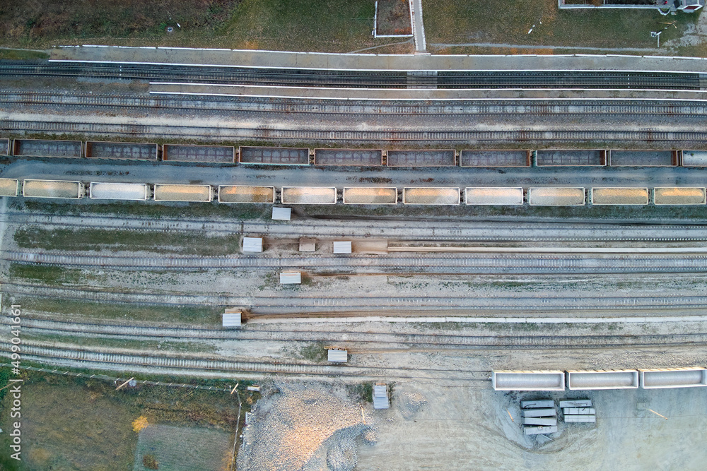 Aerial view of cargo train loaded with crushed sandstone materials at mine factory. Railway transportation of open pit mining ore Aerial view of cargo train loaded with crushed sandstone materials at mine factory. Railway transportation of open pit mining ore