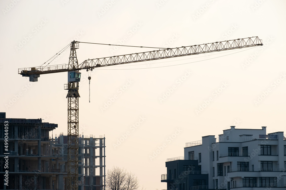 Fototapeta premium Tower cranes and high residential apartment buildings under construction. Real estate development